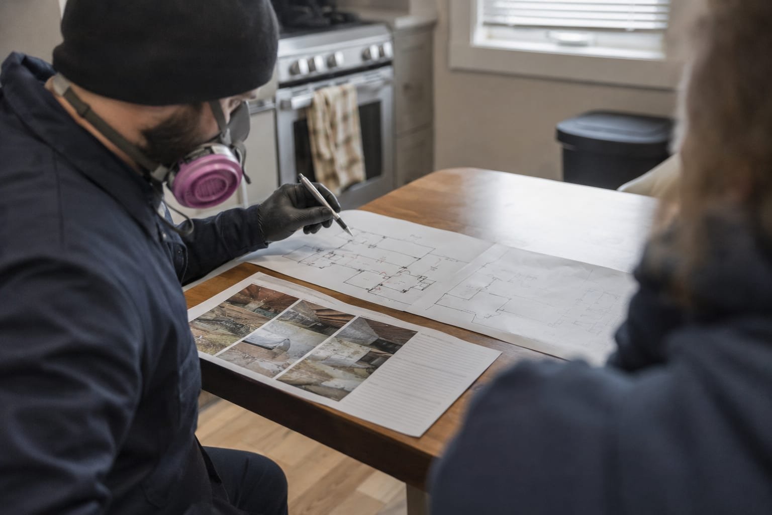 Pest control technician reviewing written inspection findings with a homeowner in Worcester, MA
